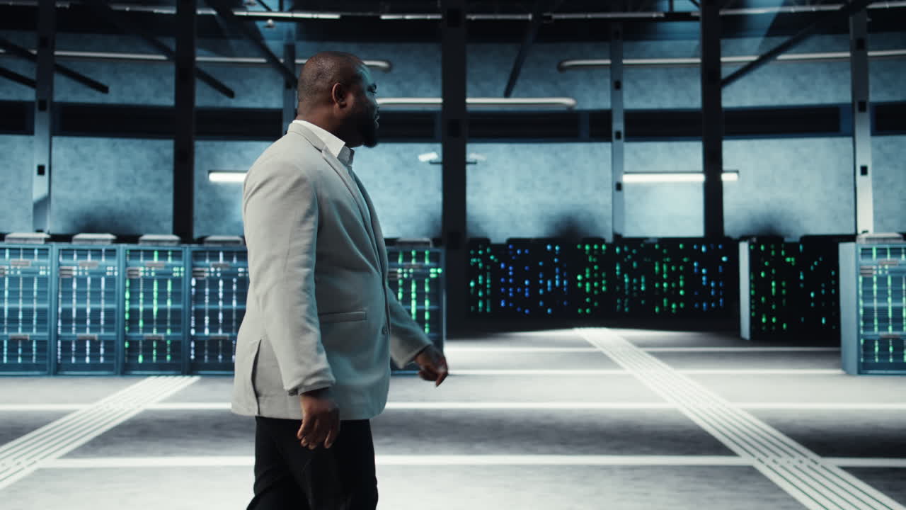 Vertical video Employee walking in high tech data center with hardware used to host websites