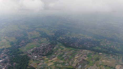 high angle aerial view of indonesia landscape with towns and fields