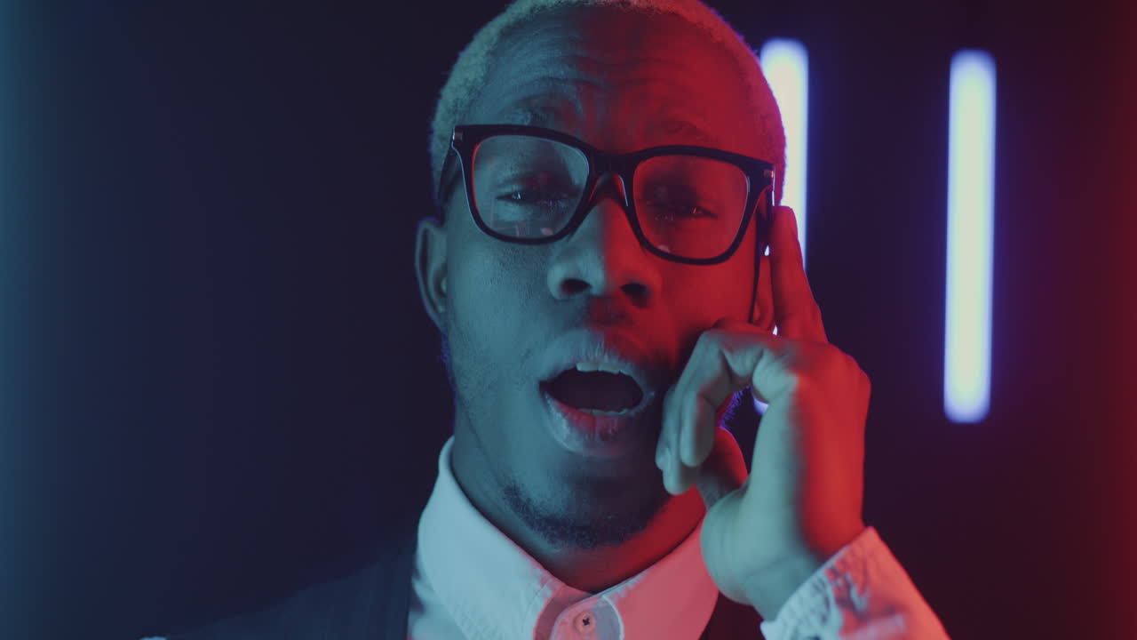 Stylish Black Man Posing with Neon Lights