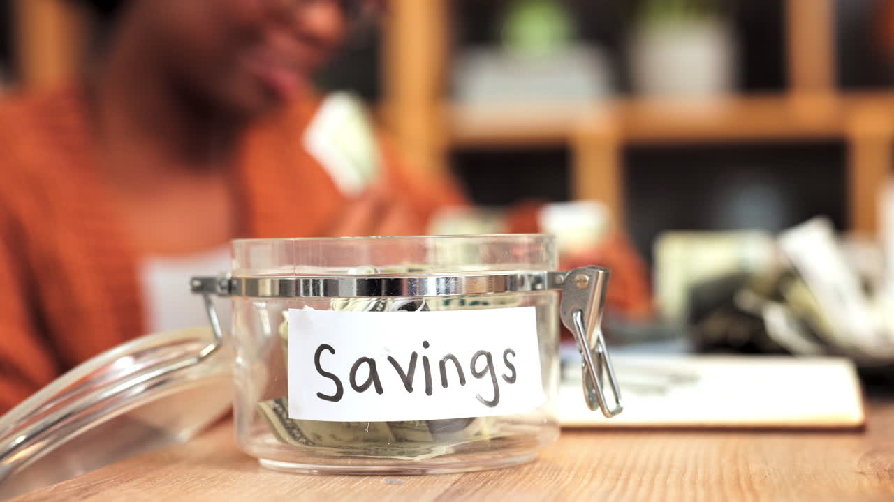 Female student taking money from glass jar