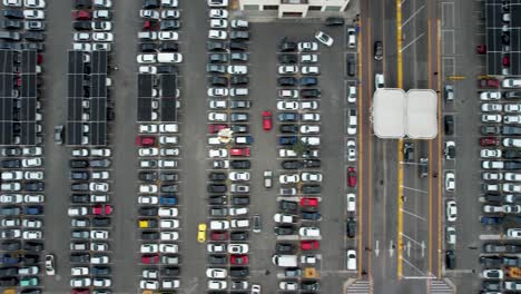 top view of parked cars in parking spots, near the shopping center