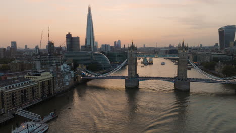 tower bridge and london skyline at sunset