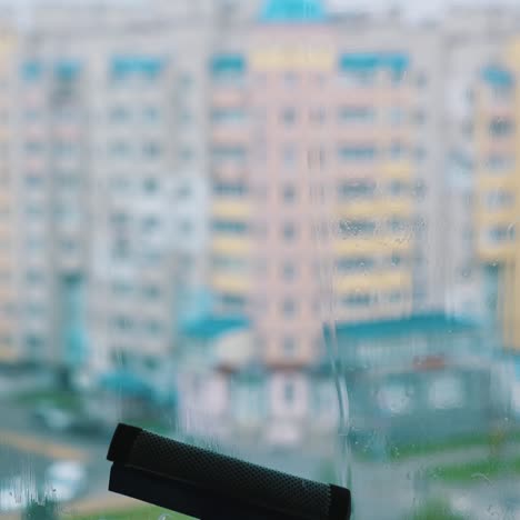 cleaning window with squeegee