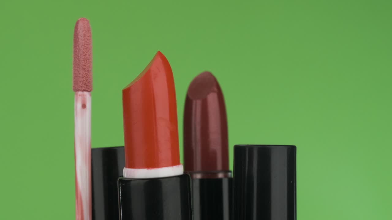 Rotation of cosmetics on a green background.