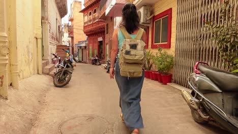 Female-tourist-walks-through-the-streets-of-an-Indian-city.-Rajasthan,-Indian-Jodhpur-Also-blue-city