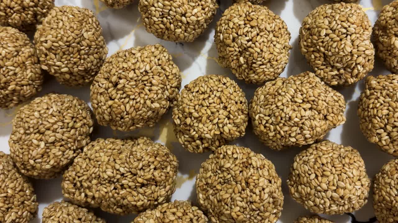 making sesame seed ladoo for festival traditional homemade dessert