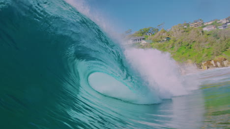 slow-motion ocean wave crashing near the shore, shot from the water at early morning, capturing the power and spray of the wave