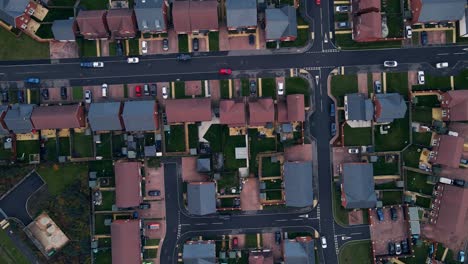 Aerial-drone-view-of-newly-built-suburban-houses,-housing-neighbourhood-located-outside-of-Chichester-England-top-down-square-moving-down