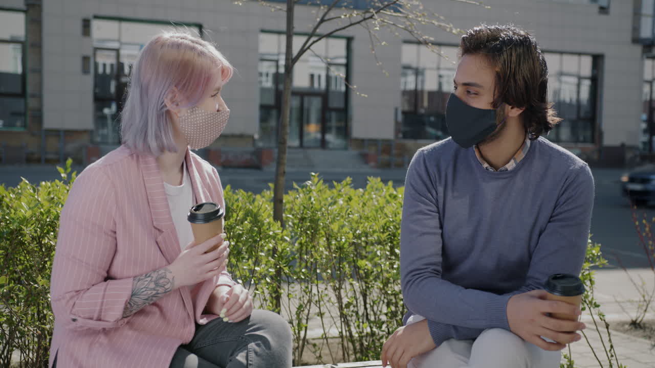 Couple with Masks Talking Outdoors