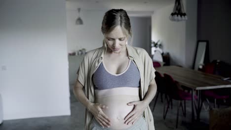 beautiful pregnant woman touching belly