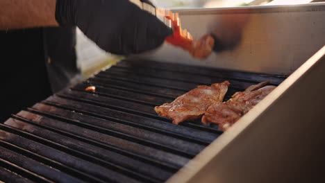 chef putting meat on the grill at a barbecue