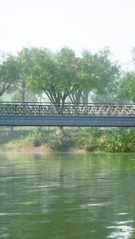 serene bridge over calm river in misty park