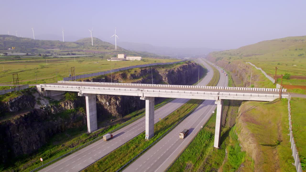 Mumbai Nagpur Expressway through wind farms, green corridor, bridge to traverse natural landscapes and waterways, Maharashtra, Drone shot