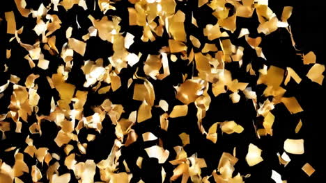 golden confetti falling on black background