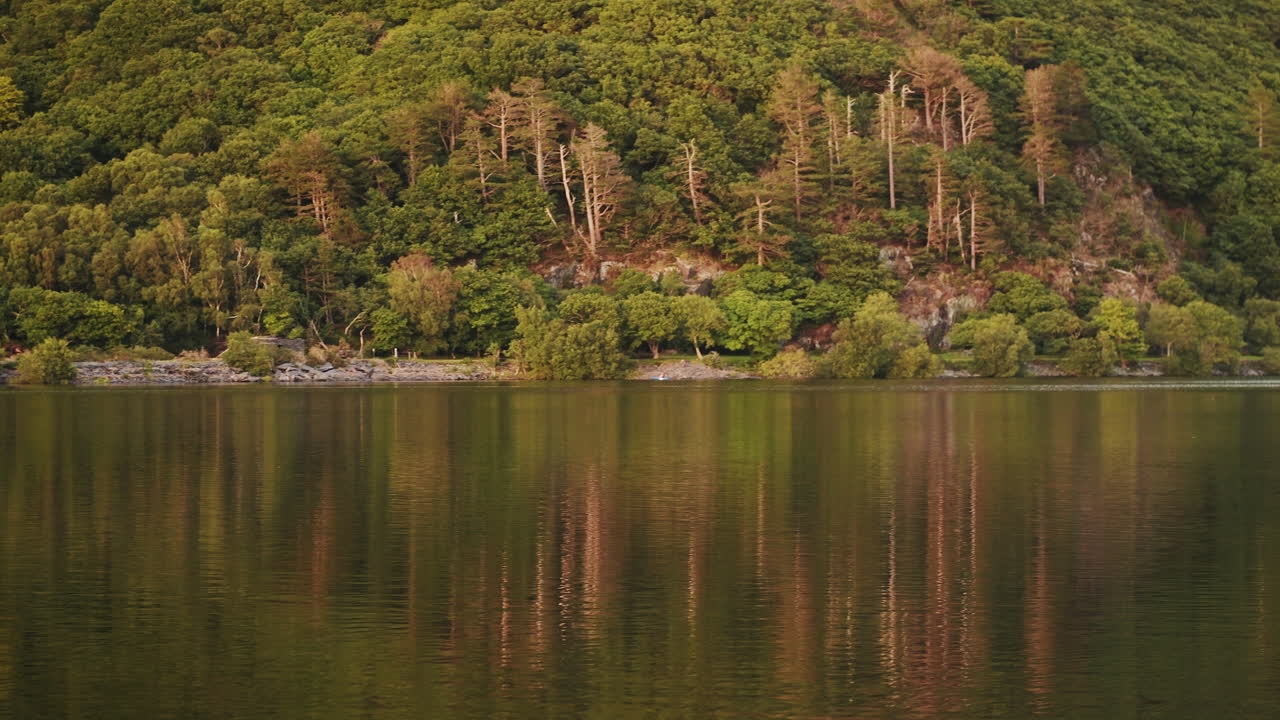 Lush Green Forest Mountain Lake Of Llyn Padarn In Snowdonia National Park In Llanberis, Wales - Wide Shot (Pan Right)