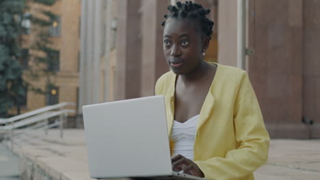 Young Woman Working on Laptop Outdoors