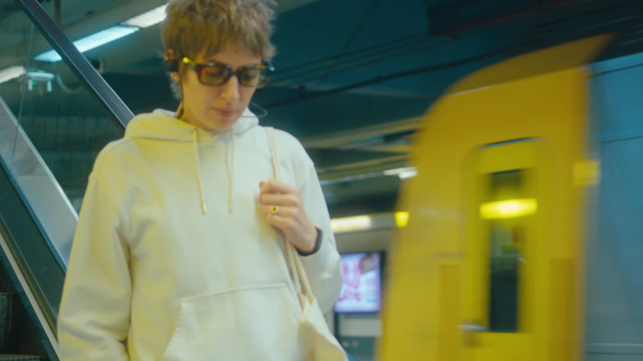 Girl Riding Escalator and Walking along Underground Station