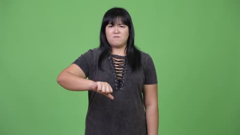 angry overweight asian woman giving thumbs down
