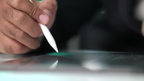 electronic signature with green light. businessman signing a business contract with stylus pen on tablet at night. man signing contract on tablet at office. business and technology concept.