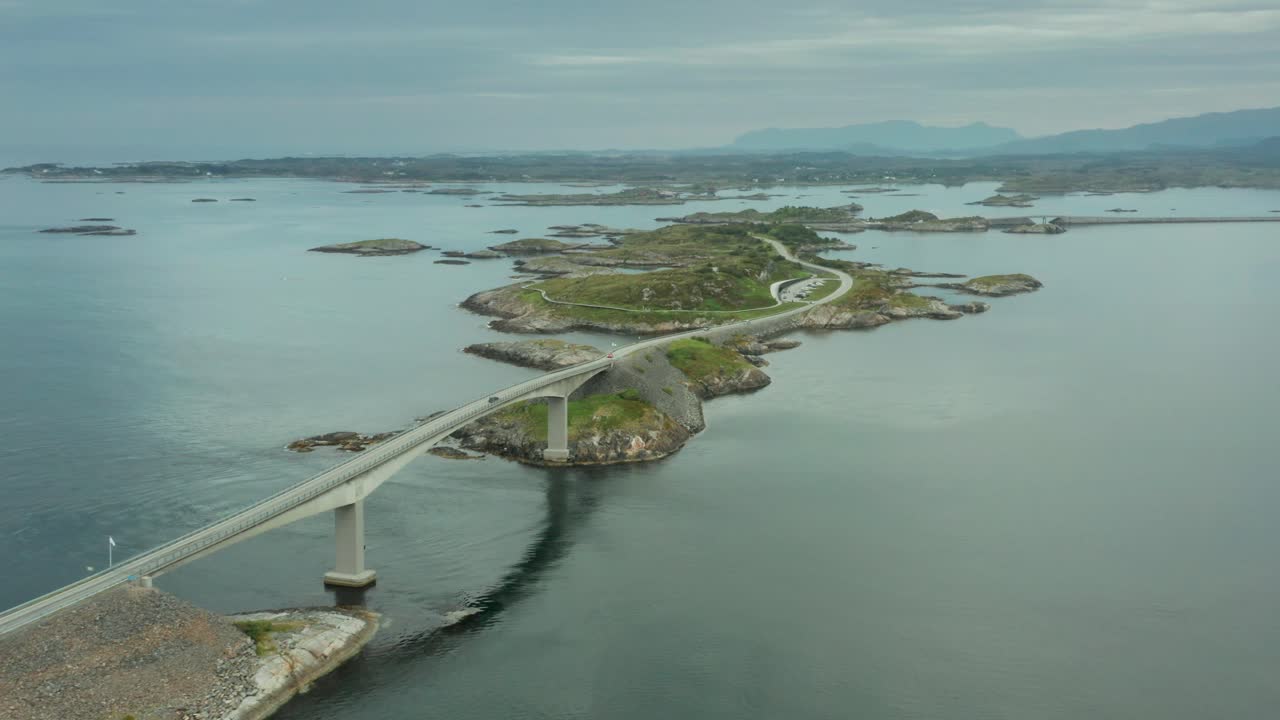 Aerial high angle overview of Atlanterhavsvegen bridge in Nordmore, Norway as car drives over