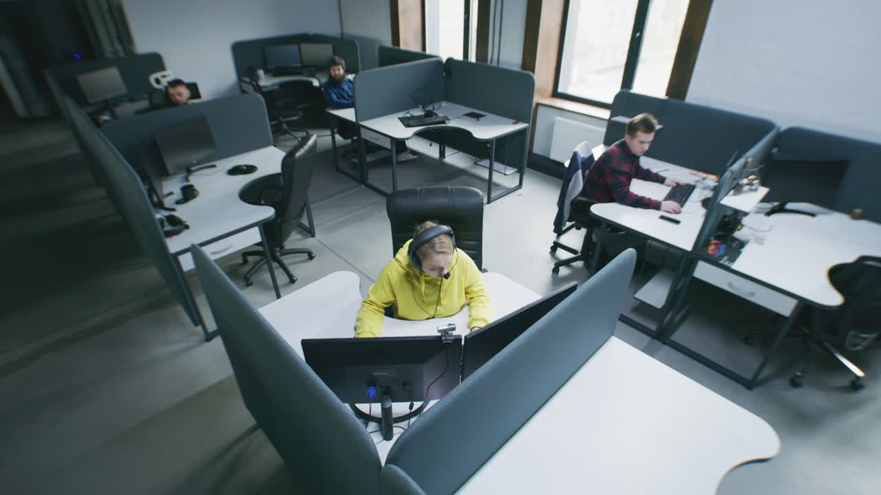 View of people working in a modern office with cubicles