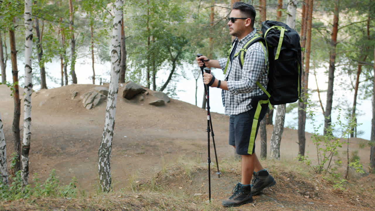 Man Hiking in the Forest by a Lake