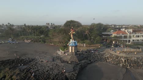 Beach-aerial-orbits-Gajah-Mina-Statue-and-kite-on-Pererenan-Beach-Bali