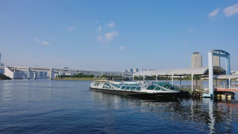 tokyo bay at odaiba, water taxi in harbor on beautiful sunny day in japan 4k