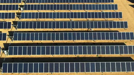 solar panel field in mojave desert, aerial pan left during the day, photovoltaic concept