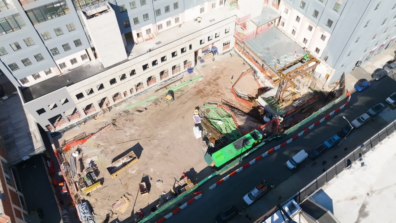 High angle drone shot overlooking a construction site in Brooklyn, sunny day