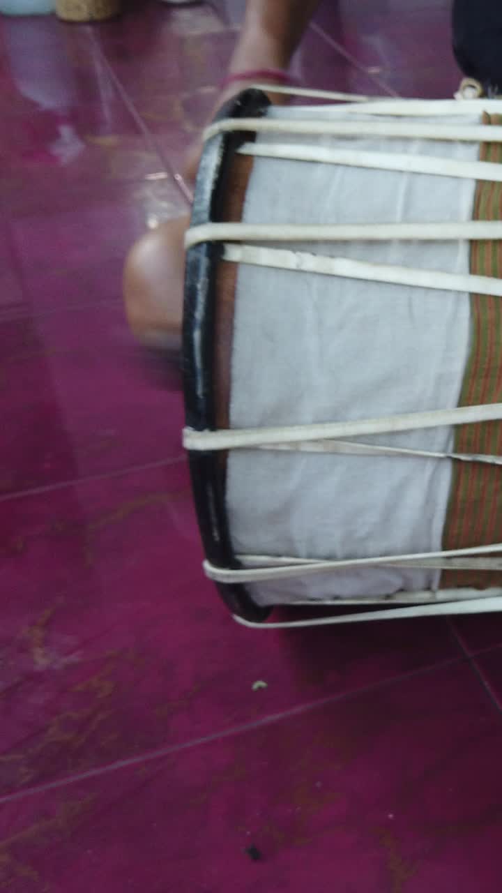 Vertical view of Gamelan Kendang percussion Drums, musician plays instrument handcrafted