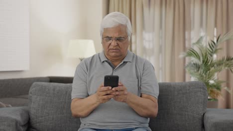 Angry-Indian-old-man-chatting-on-phone