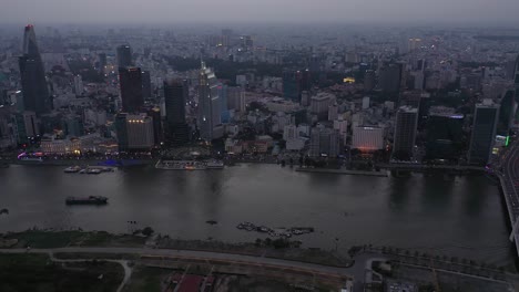 Ho-Chi-Minh-City,-Vietnam-iconic-Skyline-and-Saigon-river-waterfront-aerial-shot-of-bridge-and-key-buildings-of-skyline