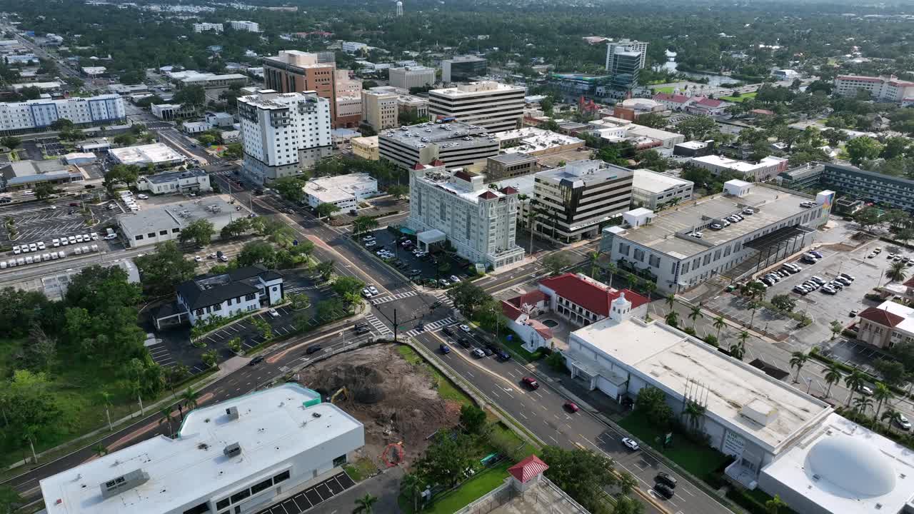 Cars on Main junction in Bradenton downtown, Florida. Sunrise time in the morning. Aerial top down shot. Office blocks and buildings in city of USA. Summer season. FL, USA