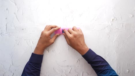 mans hands taking medicine from a pill box