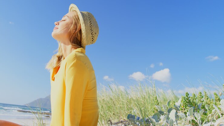 Side view of young Caucasin woman standing on the beach 4k