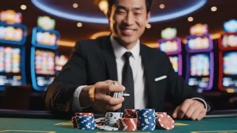 man playing poker with chips at a casino table