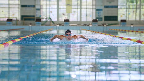 front view of a female swimmer performing butterfly technique, slow motion