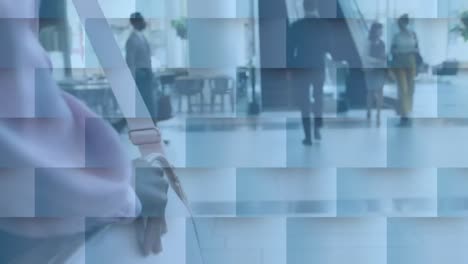 Neon-round-scanner-against-mid-section-of-businesswoman-walking-towards-escalator-at-office