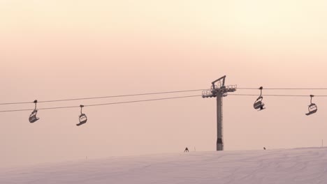 ﻿﻿skiers ride chair lift to top of ski run myrkdalen resort, norway