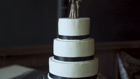 Three-tier-wedding-cake-topped-with-bride---groom-figures