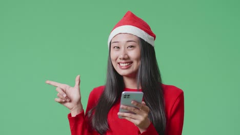 woman in santa hat using phone
