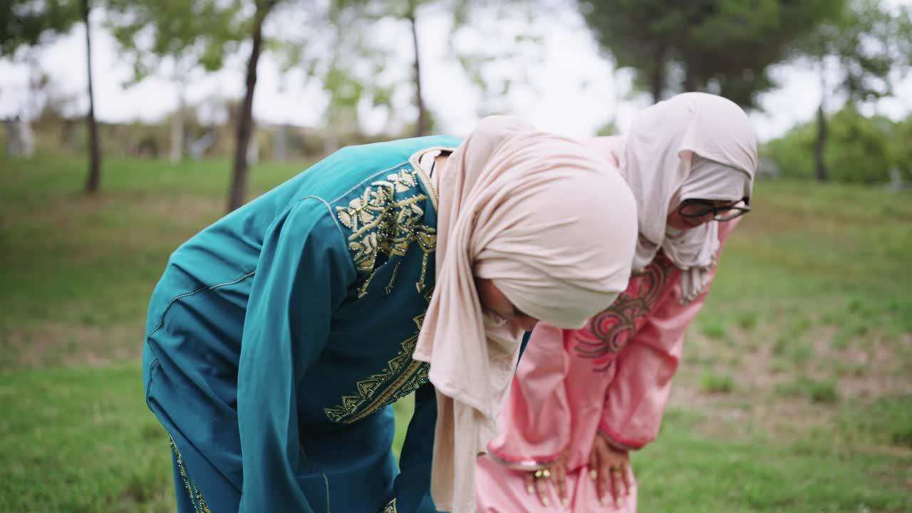 Two Muslim Women Praying Outdoors