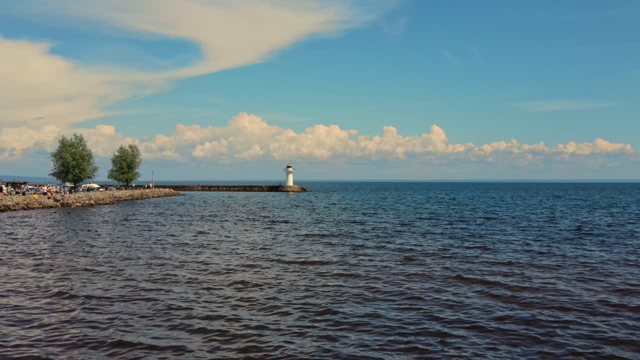 The Southern Lighthouse At The End Of A Stone Pier In Hjo, Sweden - aerial drone shot