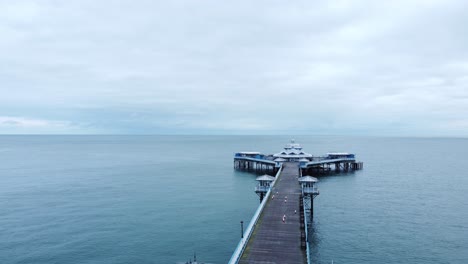 llandudno pier historic victorian wooden seaside landmark aerial view flying down boardwalk