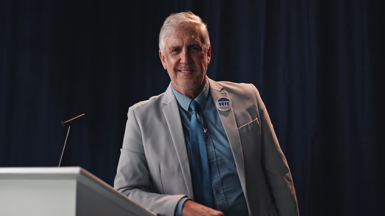 Politician smiling with arms crossed at podium