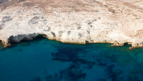 sarakiniko beach, sand rock formation coastline and caves, milos island, greece