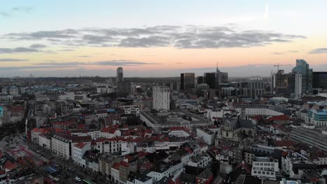 aerial downward flight over brussels city on blue and cloudy day, belgium