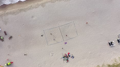 aerial: rotating shot of volleyball court on a sea sandy beach