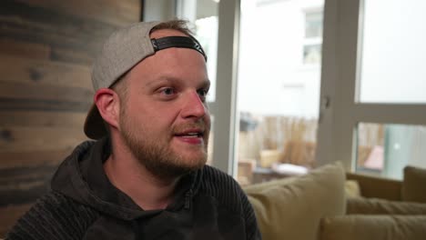 gaming - millennial man loses at a video game, puts hand on head, close up